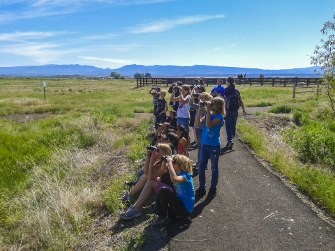 Kids view wildlife using binoculars at Modoc NWR.