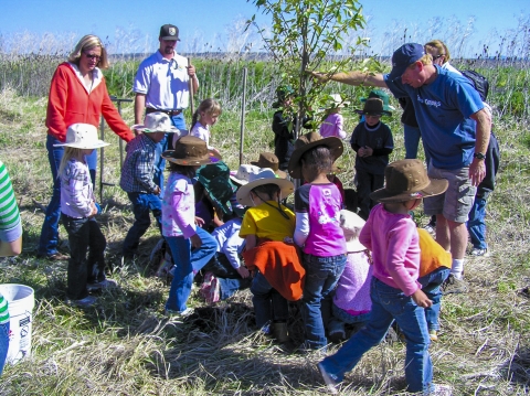 FWS staff works with students to plant a tree at Modoc NWR.