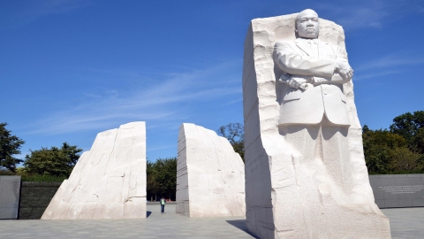 Martin Luther King Memorial, with his image carved into ivory-colored rock; 2 quarter circle rocks behind