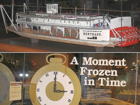 A model of a Civil War-era paddlewheel steamboat and a sign that reads "A Moment Frozen in Time"