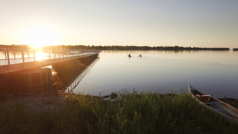 A rising sun shines on a new fishing pier at Detroit River International Wildlife Refuge.