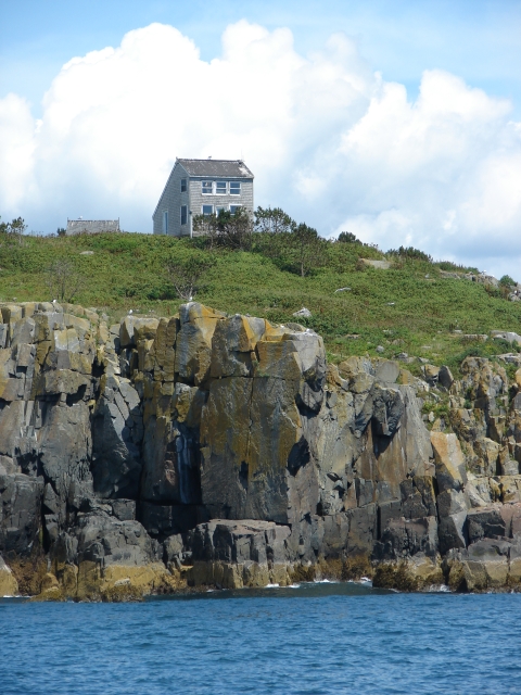 House on coastal island near shore cliffs