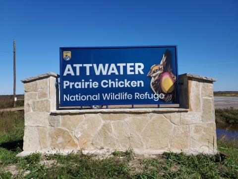 a sign with text "attwater prairie chicken national wildlife refuge"