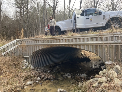 Service biologists examine the arched bottomless culvert at Smith Creek in Calhoun County, Mississippi. (USFWS Photo by Angeline Rogers)