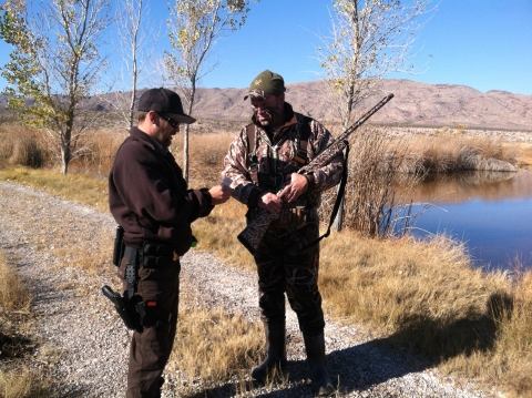 USFWS law enforcement officer checking hunting tags