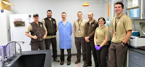 Seven FWS staff pose at Whitney Genetics Lab