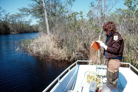 Refuge Ranger recording data from the boat