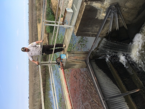 Refuge staff member operating irrigation dam