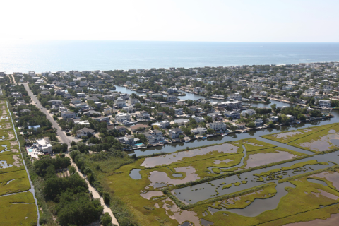 Aerial view of salt marsh and bordering development.