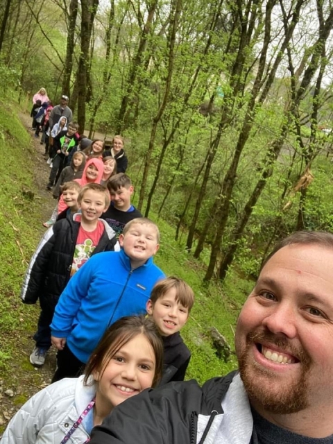 teacher and students on a nature trail 