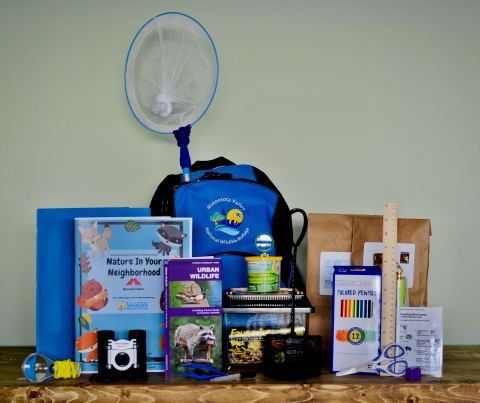 Display of youth backpack contents for outdoor activities and exploration