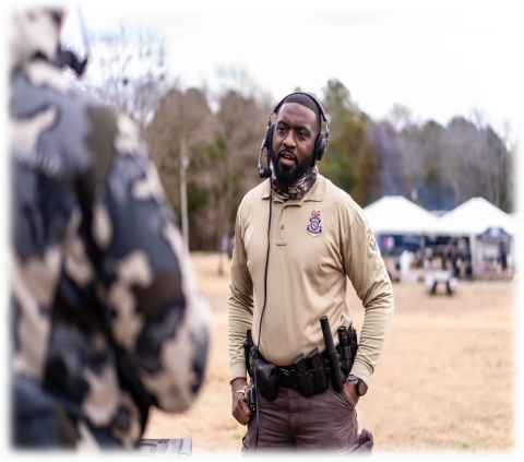 A man wearing a headset outside in a field