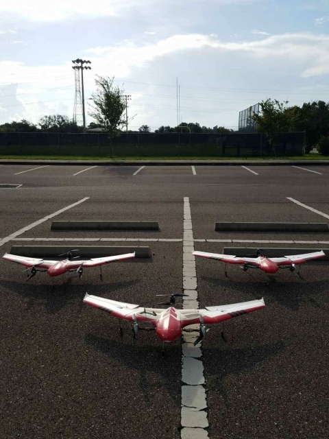 three remote planes in a parking lot