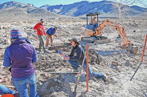 People planting trees in the desert