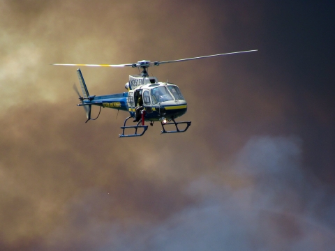 Helicopter with smoke in background