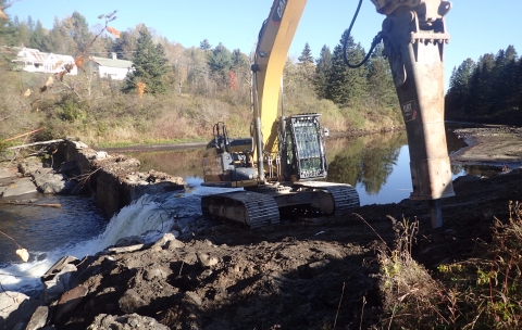 large construction equipment on the river's edge