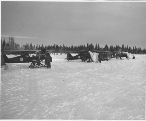 water planes on snowy airfield with personal