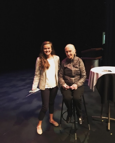 Two people posing for a photo next to a table.