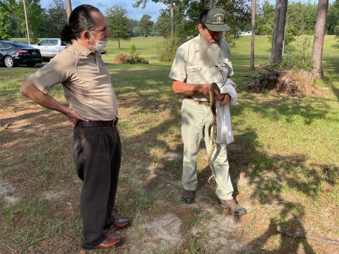 U.S. Forest Service Biologist Steve Shively holds Mr. Snake, a Louisana pinesnake that helps the U.S. Forest Service with education and outreach July 11, 2022. 