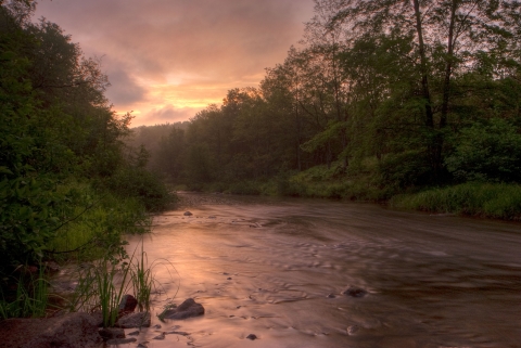 The sun behind clouds over the Blackwater River, WV