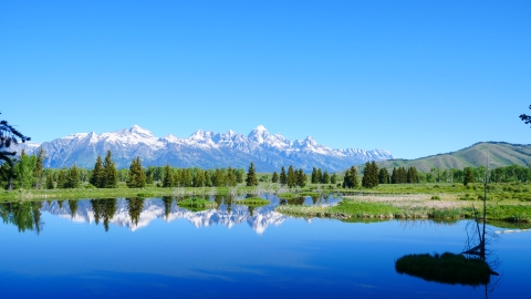 Mountains in the background of a large lake