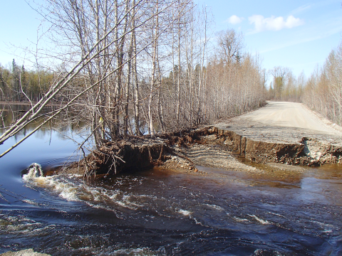 A culvert has failed and washed this rural Alaska dirt road away.