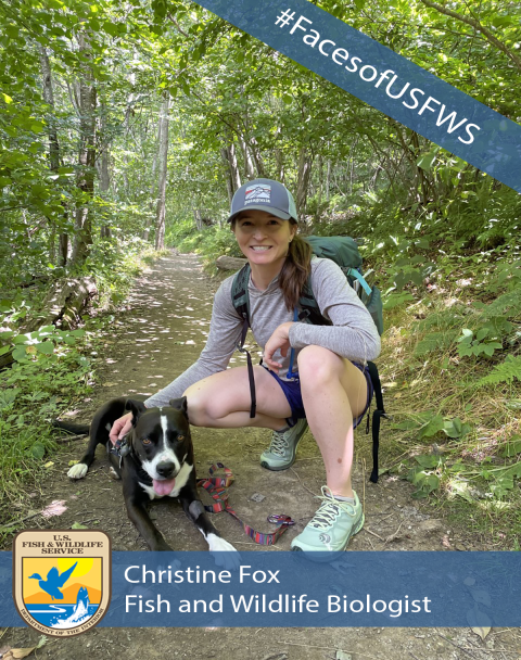 A women crouching on a hiking trail next to a brown and white dog. A banner in the top right corner reads "#FacesofUSFWS". A banner across the bottom has the U.S. Fish and Wildlife Service logo and reads "Christine Fox. Fish and Wildlife Biologist"