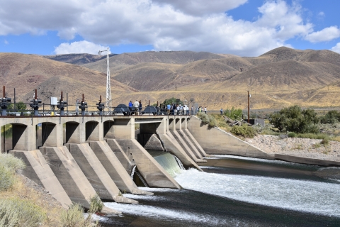 a dam on a large river surrounded by mountains