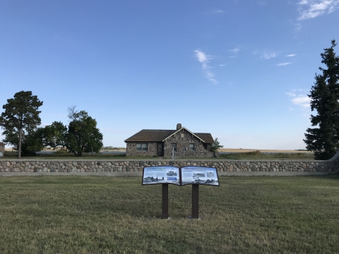 Interpretive panel at stone home