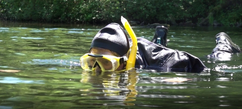 Service intern, Suzena Arias, snorkeling in a stream in search of fish