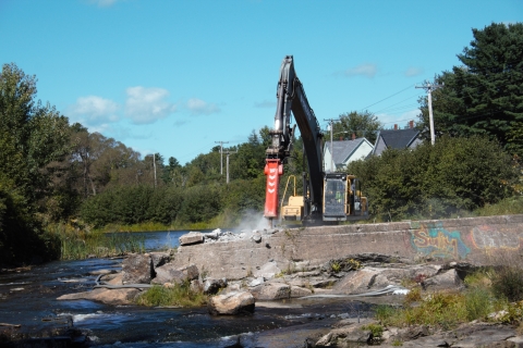 large jackhammer removes concrete dam