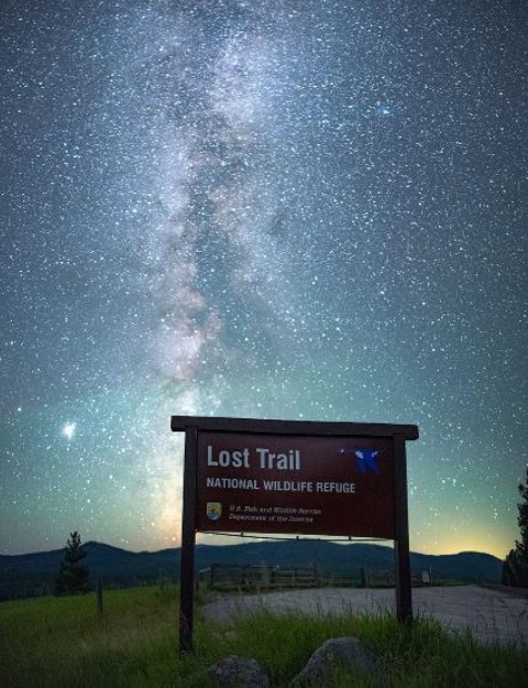 The Milky Way alights the entrance sign to Lost Trail National Wildlife Refuge 
