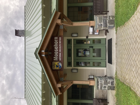 an entrance to a wildlife refuge. The sign on the entrance reads "Moosehorn National Wildlife Refuge"