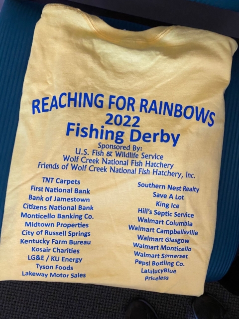 Yellow t-shirt with sponsor list for Wolf Creek NFH fishing event