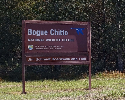 Sign with blue goose logo reads Bogue Chitto National Wildlife Refuge, USFWS Jim Schmidt boardwalk and trail