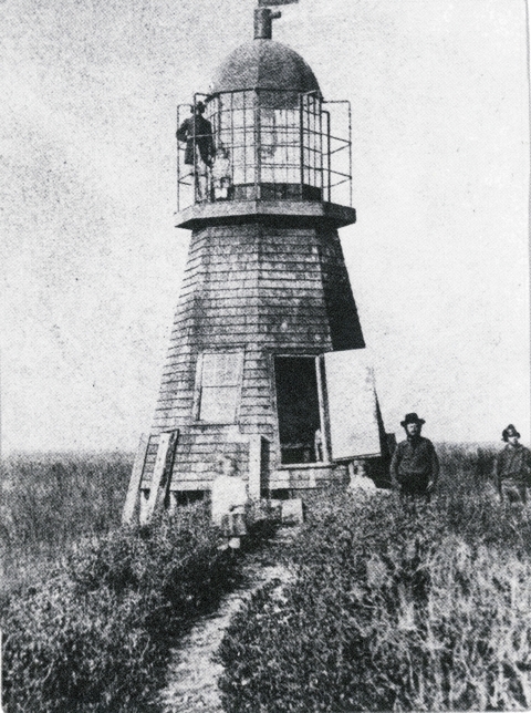 The Wolf Island Lighthouse in a very old black and white photo.