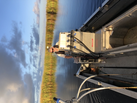 USFWS employee driving electrofishing boat