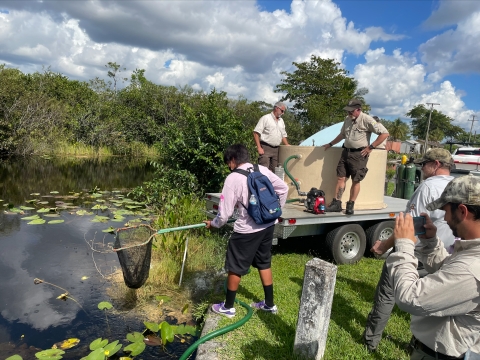 Students of the Miccosukee Tribe School helping stock fish