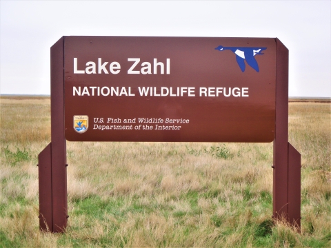 A brown sign for Lake Zahl National Wildlife Refuge.