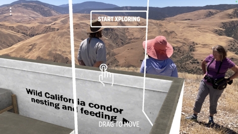 Three people overlooking a vast mountainous area. A virtual reality filter has been placed over the image so that it appears that the three people are located near a feeding station for California condors
