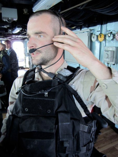 A man in uniform with a headset on