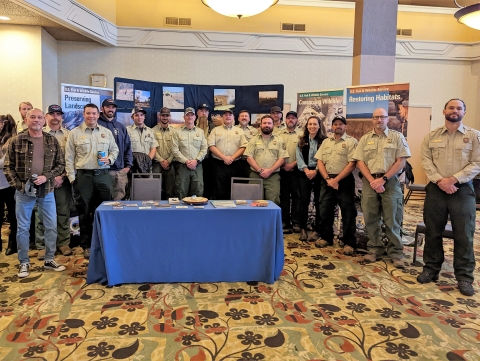 group poses around table in conference room