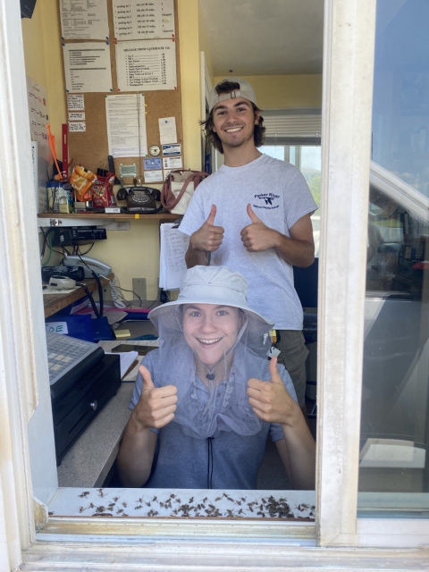 Image of two interns in a gatehouse window