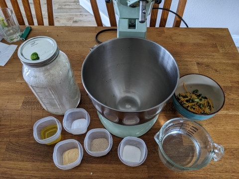A table laid with all of the ingredients needed to make jalapeno cheddar bread