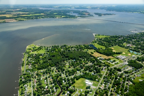 An aerial view of a community on a wide river