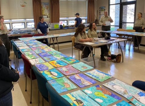 artwork on tables ready to be judged 