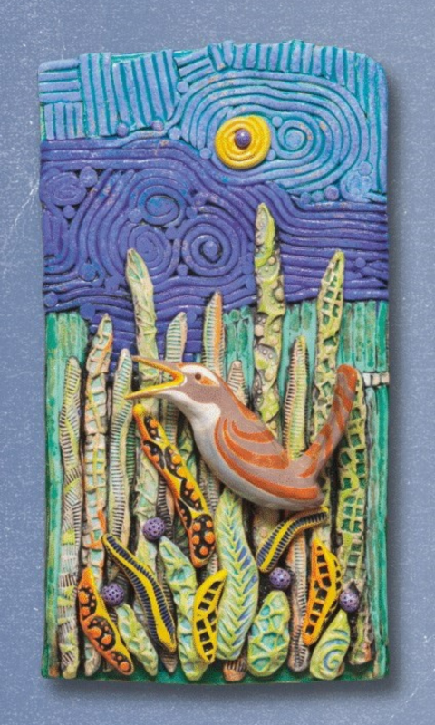 Clay art of a singing bird perched on long, green plants