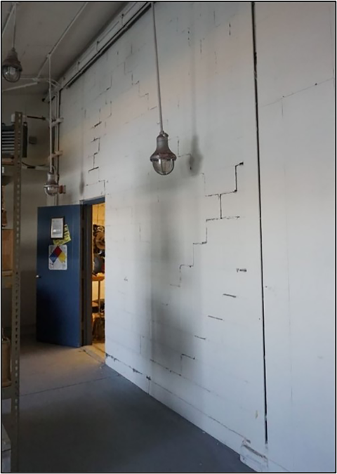 Cracks in a block wall inside a hangar after an earthquake. 