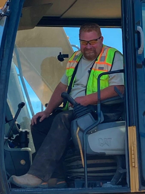 Man sitting in a tractor cab