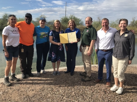 Picture of eight people representing Audubon Southwest, Phoenix Parks and Recreation, City of Phoenix Mayor, Region 2 Director, Maricopa County Parks and Recreation, Executive Director of Audubon Southwest, and Arizona Ecological Services staff. The Mayor and Regional Director are holding the Urban Bird Treaty.